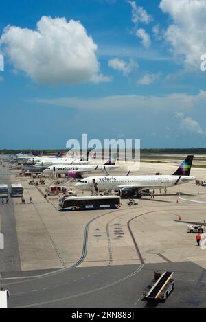 cancun, quintana roo, 20 08 23, Mexican airline planes parked on the airport runway with passenger transport vehicles around them, air traffic Stock Photo