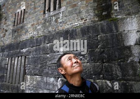 Li Qingyi regarde les vieux bâtiments de la ville d'Apengjiang, dans le district de Qianjiang à Chongqing, dans le sud-ouest de la Chine, le 18 octobre 2015. La Chine va marquer le prochain Festival de Chongyang, la journée chinoise pour les personnes âgées, qui aura lieu mercredi et où les gens exprimeront leurs respects aux personnes âgées de différentes manières. La fête millénaire de Chongyang tombe le neuvième jour du neuvième mois du calendrier lunaire chinois. (wsw) CHINA-CHONGYANG FESTIVAL (CN) YangxMin PUBLICATIONxNOTxINxCHN Senior Citizen Left Qingyi regarde les vieux bâtiments de la ville du district de Qianjiang de Cho Banque D'Images