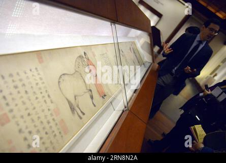 (151030) -- NEW YORK, Oct. 30, 2015 -- A visitor attends the media preview of an exhibition named Masterpieces of Chinese Painting from the Metropolitan Collection at the Met Museum in New York, the United States, Oct. 30, 2015. Featuring more than 110 works dating from the Tang Dynasty (608-917) to the present in two rotations, Masterpieces of Chinese Painting from the Metropolitan Collection provided visitors with a rare opportunity to learn about the history of Chinese painting and calligraphy through some of the best examples available from each era. ) U.S.-NEW YORK-MET MUSEUM-CHINESE PAIN Stock Photo