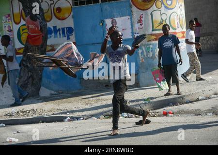 (151107) -- PORT-AU-PRINCE, Nov. 6, 2015 -- A youngster reacts while the police disperse demonstrators during a rally against the results of the presidential elections in Port-Au-Prince, Haiti, on Nov. 6, 2015. Residents took to the streets of the Haitian capital on Friday to express rejection to the results of the last presidential elections, while the government reaffirmed its support to the electoral process and guaranteed that it will keep the order in the country. Supporters of Celestin and Jean-Charles, second and third according to the counting of the votes, marched in the Delmas munici Stock Photo