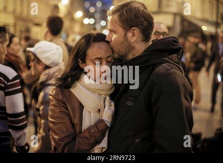 (151122) -- BEIJING, Nov. 22, 2015 -- A couple mourns for victims in front of the Le Petit Cambodge Restaurant where a terror attack happend on Nov. 13 in Paris, France, Nov. 14, 2015. ) Xinhua Photo Weekly Choices ZhouxLei PUBLICATIONxNOTxINxCHN   151122 Beijing Nov 22 2015 a COUPLE mourns for Victims in Front of The Le Petit Cambodge Restaurant Where a Terror Attack Happend ON Nov 13 in Paris France Nov 14 2015 XINHUA Photo Weekly Choices ZhouxLei PUBLICATIONxNOTxINxCHN Stock Photo