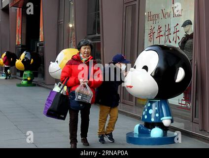 (160203) -- SHANGHAI, Feb. 3, 2016 -- Pedestrians are attracted by a monkey figurine on the Nanjing West Road in Shanghai, east China, Feb. 3, 2016. A total of 100 lovely monkey figurines have been placed on the Nanjing West Road, a prosperous commericial street, in Shanghai, to create a New Year atmosphere. ) (lfj) CHINA-SHANGHAI-MONKEY FIGURINES (CN) LiuxYing PUBLICATIONxNOTxINxCHN   Shanghai Feb 3 2016 pedestrians are attracted by a Monkey Figurine ON The Nanjing WEST Road in Shanghai East China Feb 3 2016 a total of 100 Lovely Monkey Figurines have been placed ON The Nanjing WEST Road a Pr Stock Photo