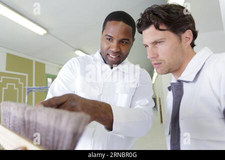 two painters looking at brushes Stock Photo