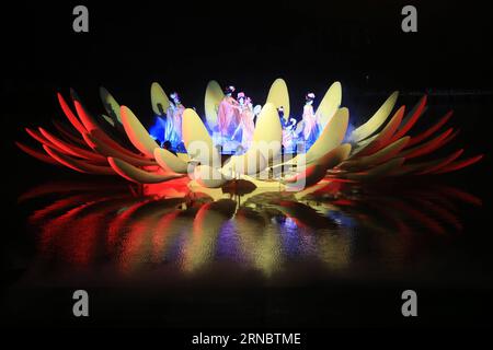 (160312) -- KAIFENG, March 11, 2016 -- Actresses dance in a blossoming lotus during an on-water performance reproducing the prosperity of capital city Kaifeng (historically known as Daliang, Bianliang, Bianjing, Dongjing) of Northern Song Dynasty (960-1127 AD) in Kaifeng, Central China s Henan Province, March 11, 2016. ) (wyl) CHINA-HENAN-WATER-PERFORMANCE (CN) LixJunsheng PUBLICATIONxNOTxINxCHN   160312 Kaifeng March 11 2016 actresses Dance in a blossoming Lotus during to ON Water Performance reproducing The Prosperity of Capital City Kaifeng historically known As Daliang  Bianjing Dong Jing Stock Photo