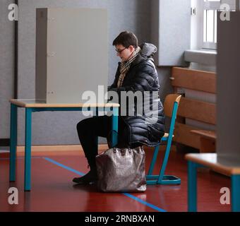 (160313) -- MAINZ, March 13, 2016 -- Ms. Eckert fills in her ballot at a polling station in Mainz, Germany, March 13, 2016. State elections in three German states: Rhineland-Palatinate, Saxony-Anhalt and Baden-Wuerttemberg, is held on Sunday, which is a crucial test-case for German Chancellor and Chairwoman of the German Christian Democrats (CDU) Angela Merkel, who has come under increasing pressure over her immigration policy towards migrants and refugees. Germany s anti-migration party, the Alternative for Germany has solid polling numbers and will almost certainly win seats in all three sta Banque D'Images