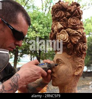 (160323) -- KATMANDOU, le 23 mars 2016 -- Un artiste britannique donne sa touche finale à son artisanat lors du 4e Festival du bois organisé à l'occasion de la Journée mondiale du bois à Katmandou, capitale du Népal, le 23 mars 2016. Le festival est un événement culturel organisé chaque année pour mettre en valeur le bois en tant que biomatériau écologique et renouvelable et démontrer le rôle clé du bois dans un avenir durable. Plus de 90 stands de divers pays du monde ont exposé leurs travaux artisanaux. ) NEPAL-KATHMANDU-WOODCRAFT FESTIVAL SunilxSharma PUBLICATIONxNOTxINxCHN Katmandou Mars 23 2016 un artiste britannique donne Banque D'Images