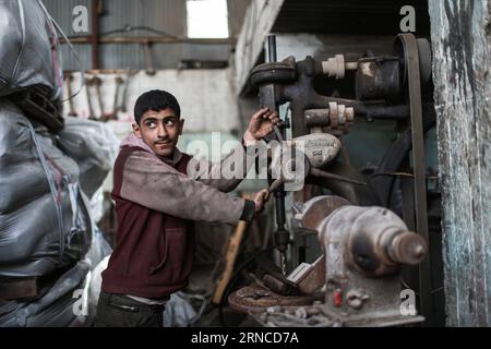 (160405) -- GAZA, April 5, 2016 -- Palestinian boy Salah Dalloul, 13, who works as mechanic to help his father support their family, is seen at a garage in Gaza City on April 5, 2016. Many Palestinian young boys are trying to make a living and support their family. ) MIDEAST-GAZA-PALESTINIAN-CHILD WissamxNassar PUBLICATIONxNOTxINxCHN   Gaza April 5 2016 PALESTINIAN Boy Salah  13 Who Works As Mechanic to Help His Father Support their Family IS Lakes AT a Garage in Gaza City ON April 5 2016 MANY PALESTINIAN Young Boys are trying to Make a Living and Support their Family Mideast Gaza PALESTINIAN Stock Photo