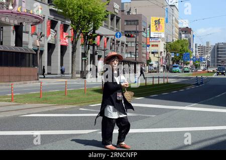 (160417) -- KUMAMOTO, April 17, 2016 -- An elderly lady walks past empty city center of the earthquake rocked Kumamoto prefecture, Japan, April 17, 2016. A powerful magnitude-7.3 earthquake struck the island of Kyushu in southwestern Japan early Saturday just a day after a sizable foreshock hit the region, with the number of fatalities now standing at 41 according to the latest figures on Sunday. ) (djj) JAPAN-KUMAMOTO-EARTHQUAKE-AFTERMATH MaxPing PUBLICATIONxNOTxINxCHN   160417 Kumamoto April 17 2016 to Elderly Lady Walks Past Empty City Center of The Earthquake Rocked Kumamoto Prefecture Jap Stock Photo