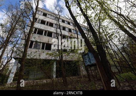 (160424) -- CHERNOBYL, April 24, 2016 -- Photo taken on April 19 2016 shows a deserted building in Pripyat city near Chernobyl, Ukraine. Chernobyl, a place replete with horrific memories in northern Ukraine, close to Belarus, is now open to tourists, almost 30 years to the date after a nuclear power plant there exploded. It was the worst nuclear accident in human history. A large tract of land around the plant was designated a forbidden zone and ordinary people were completely prohibited from entering after the disaster occurred on April 26, 1986. The accident released more than 8 tons of radi Stock Photo