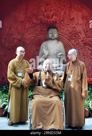 (160430) -- SHIJIAZHUANG, April 30, 2016 -- Master Hsing Yun (C), founder of Fo Guang Shan Monastery in southeast China s Taiwan, speaks in front of the complete Buddha statue at Hebei Museum in Shijiazhuang, capital of north China s Hebei Province, April 30, 2016. The white marble Buddha statue, which was made around 556 by North Qi dynasty, was originally worshipped at Youju Temple in Hebei Province, where the Buddha s head was stolen in 1996. Master Hsing Yun, founder of Fo Guang Shan Monastery in southeast China s Taiwan, decided to return the 80 kg statue head to the mainland after it was Stock Photo
