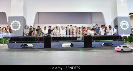 (160519) -- BEIJING, May 19, 2016 -- Visitors look at a model of an electric lane-straddling bus at the 19th China Beijing International High-tech Expo, in Beijing, capital of China, May 19, 2016. ) (wyl) CHINA-BEIJING-HIGH-TECH EXPO (CN) LixWen PUBLICATIONxNOTxINxCHN   160519 Beijing May 19 2016 Visitors Look AT a Model of to Electric Lane straddling Bus AT The 19th China Beijing International High Tech EXPO in Beijing Capital of China May 19 2016 wyl China Beijing High Tech EXPO CN LixWen PUBLICATIONxNOTxINxCHN Stock Photo