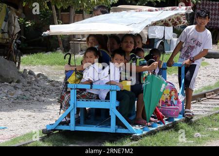 (160613) -- MUNTINLUPA CITY (THE PHILIPPINES), June 13, 2016 -- Students and their parents ride a makeshift trolley as they go to school in Muntinlupa City, the Philippines, on June 13, 2016. Around 25 million students attended elementary and high school classes all over the country at the beginning of the school year 2016-2017, according to the Philippine Department of Education. ) THE PHILIPPINES-MUNTINLUPA CITY-FIRST DAY OF SCHOOL RouellexUmali PUBLICATIONxNOTxINxCHN   160613 Muntinlupa City The Philippines June 13 2016 Students and their Parents Ride a makeshift Trolley As They Go to Schoo Stock Photo