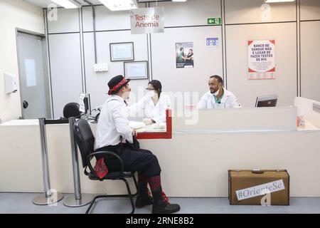 (160614) -- SAO PAULO, June 14, 2016 -- Image taken on June 9, 2016, shows Gilberto Kido (Front) receiving blood test before a voluntary blood donation at the Pro Sangre Foundation in Sao Paulo, Brazil. Gilberto Kido has been a voluntary blood donor for the last 30 years after his mother died while waiting for a kidney transplant. Using his clown character, Kido has an objective to encourage the blood donation for saving lives. The World Blood Donor Day is celebrated every year on June 14. In 2016 the theme of the campaign is Blood connects us all , the World Health Organization (WHO) has also Stock Photo