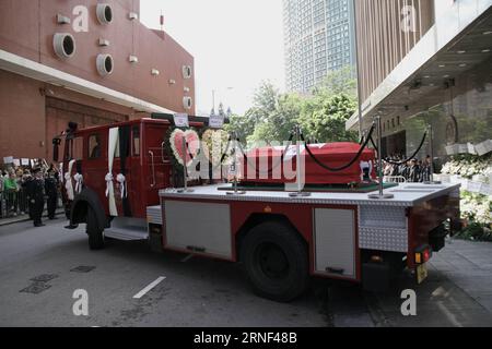 (160717) -- HONG KONG, July 17, 2016 -- A hearse carrying the coffin of Thomas Cheung pulls out of the Universal Funeral Parlor in Hung Hom in south China s Hong Kong, July 17, 2016. An official police funeral with full honor was held here Sunday for Thomas Cheung, a 30-year-old senior station officer who died while battling fire in an industrial building in Hong Kong s East Kowloon on June 25, 2016.)(wjq) CHINA-HONG KONG-FIREFIGHTER-FUNERAL (CN ) WangxShen PUBLICATIONxNOTxINxCHN   160717 Hong Kong July 17 2016 a Hearse carrying The Coffin of Thomas Cheung pull out of The Universal Funeral Par Stock Photo