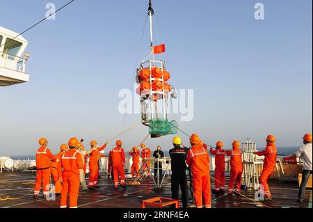 (160718) -- ABOARD ZHANG JIAN, July 16, 2016 -- Staff practice placing Rainbow Fish, a submersible capable of diving up to 11,000 meters in the sea, on research vessel Zhang Jian in South China Sea, July 16, 2016. The vessel will test the ship s navigation abilities and equipment during its two-month voyage to the Southern Pacific. The destination is the waters near the New Britain Trench, which is more than 8,000 meters deep in the Solomon Sea near Papua New Guinea. The ship is 97 meters long and 17.8 meters wide. It has a designed displacement of around 4,800 tonnes and an endurance of 15,00 Stock Photo