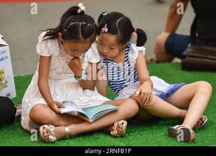 BAOTOU, July 28, 2016 -- Two girls read on ground at the 26th National Book Trading Expo in Baotou, north China s Inner Mongolia Autonomous Region, July 28, 2016. The expo with some 230,000 publications opened here on Thursday. ) (cxy) CHINA-BAOTOU-BOOK TRADING EXPO (CN) LianxZhen PUBLICATIONxNOTxINxCHN   Baotou July 28 2016 Two Girls Read ON Ground AT The 26th National Book Trading EXPO in Baotou North China S Inner Mongolia Autonomous Region July 28 2016 The EXPO With Some 230 000 Publications opened Here ON Thursday Cxy China Baotou Book Trading EXPO CN LianxZhen PUBLICATIONxNOTxINxCHN Stock Photo