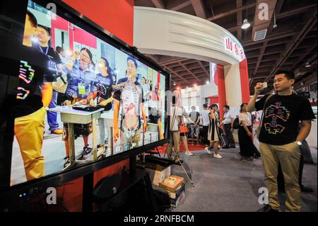 (160729) -- BAOTOU, July 28, 2016 -- An exhibitor shows product with the Augmented Reality technology during the 26th National Book Expo in Baotou, north China s Inner Mongolia Autonomous Region, July 28, 2016. The three-day expo, which kicked off here Thursday, attracted many exhibitors using new technologies like Augmented Reality and Virtual Reality. )(wjq) CHINA-INNER MONGOLIA-BOOK EXPO (CN) LianxZhen PUBLICATIONxNOTxINxCHN   160729 Baotou July 28 2016 to exhibitor Shows Product With The augmented Reality Technology during The 26th National Book EXPO in Baotou North China S Inner Mongolia Stock Photo