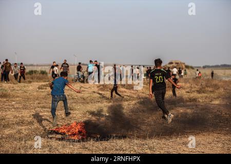 Gaza, Gaza, Palestine. 1st Sep, 2023. Two children jump over the fire on the Gaza Strip border (Credit Image: © Saher Alghorra/ZUMA Press Wire) EDITORIAL USAGE ONLY! Not for Commercial USAGE! Stock Photo