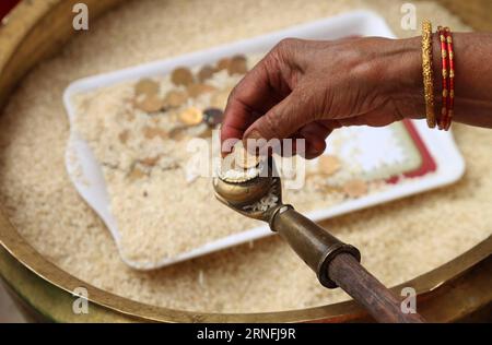 (160812) -- LALITPUR (NEPAL), Aug. 11, 2016 -- A Buddhist gives offerings to visitors during Pancha Dan festival in Lalitpur, Nepal, Aug. 11, 2016. Pancha Dan, the festival of five summer gifts, is observed by the Buddhists by giving away five elements including wheat grains, rice grains, salt, money and fruit. ) (sxk) NEPAL-LALITPUR-PANCHA DAN FESTIVAL SunilxSharma PUBLICATIONxNOTxINxCHN   160812 Lalitpur Nepal Aug 11 2016 a Buddhist Gives offerings to Visitors during Pancha Dan Festival in Lalitpur Nepal Aug 11 2016 Pancha Dan The Festival of Five Summer Gifts IS observed by The Buddhists by Stock Photo