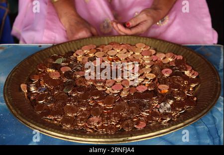 (160812) -- LALITPUR (NEPAL), Aug. 11, 2016 -- Photo taken on Aug. 11, 2016 shows a collection of coins kept for offerings to visitors by Buddhists during Pancha Dan festival in Lalitpur, Nepal. Pancha Dan, the festival of five summer gifts, is observed by the Buddhists by giving away five elements including wheat grains, rice grains, salt, money and fruit. ) (sxk) NEPAL-LALITPUR-PANCHA DAN FESTIVAL SunilxSharma PUBLICATIONxNOTxINxCHN   160812 Lalitpur Nepal Aug 11 2016 Photo Taken ON Aug 11 2016 Shows a Collection of Coins Kept for offerings to Visitors by Buddhists during Pancha Dan Festival Stock Photo