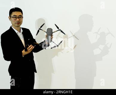 (160929) -- BEIJING, Sept. 29, 2016 -- PR Director of the DJI Wang Fan demonstrates the Mavic Pro during a press conference in Beijing, capital of China, Sept. 29, 2016. The Mavic Pro is a small yet powerful drone released by DJI, a Chinese technology company manufacturing unmanned aerial vehicles for flying cameras. DJI Mavic Pro has a stabilized camera with 12 megapixels and a new transmission system with 7 kilometers range. ) (mp) CHINA-BEIJING-DRONE-MAVIC PRO-PRESS CONFERENCE (CN) ChenxJianli PUBLICATIONxNOTxINxCHN   Beijing Sept 29 2016 PR Director of The Dji Wang supporter demonstrates T Stock Photo