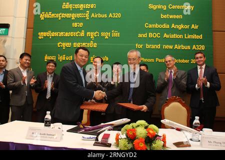 (161017) -- PHNOM PENH, Oct. 17, 2016 -- Tekreth Samrach (L, front), chairman of Cambodia Angkor Air, shakes hands with Phang Thim Fatt (R, front), deputy managing director and chief finance officer of BOC Aviation Limited, during a signing ceremony on an aircraft lease agreement in Phnom Penh, Cambodia, Oct. 17, 2016. Cambodia s national flag carrier Cambodia Angkor Air signed an agreement here on Monday to lease two brand new aircraft Airbus A320 from BOC Aviation, a member of Bank of China Group, according to an airline statement. ) (dtf) CAMBODIA-PHNOM PENH-ANGKOR AIR-BOC-LEASE AGREEMENT S Stock Photo