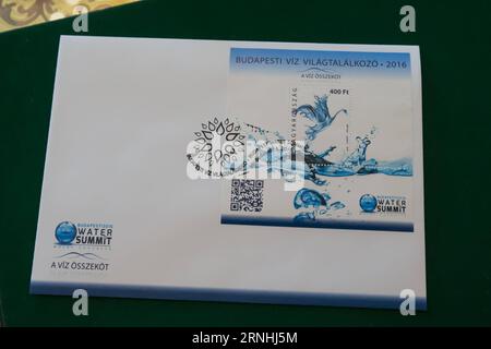 (161121) -- BUDAPEST, Nov. 21, 2016 -- The first-day cover of commemorative miniature stamp sheet marking the Budapest Water Summit is seen in Budapest, capital of Hungary, on Nov. 21, 2016. Hungarian President Janos Ader sponsored the issue of the commemorative postal stamp on Monday, to mark the Budapest Water Summit of which he is chief patron, set to begin in a week s time. The stamp, issued as a commemorative block with a face value of 400 forints (1.37 U.S. dollars) was designed by artist Anita Laczko and portrays a unique bird shaped from droplets of water rising above a water surface. Stock Photo