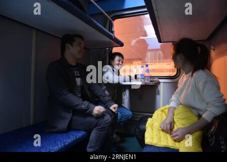 (170120) -- GUANGZHOU, 20 janvier 2017 -- Shi Xin discute avec d'autres passagers du train spécial K9064 pour rentrer chez eux, 18 janvier 2017. L'esprit le plus important du nouvel an chinois, ou festival du printemps, est la réunion de famille. C est pourquoi Shi Xin, un travailleur migrant de 33 ans, originaire du village de Liudou de Xiangxi Tujia et de la préfecture autonome de Miao, dans la province du Hunan du centre de la Chine et travaillant à Guangzhou du sud de la Chine, a passé un voyage lassé de 24 heures sur le chemin du retour, mais il en vaut toujours la peine. (wx) CHINA-SPRING FESTIVAL-A LONG WAY HOME (CN) LiangxXu PUBLICATIONxNOTxINxCHN Guangzhou Jan 20 2017 Shi Xin parle avec Banque D'Images