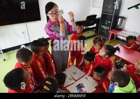 (170603) -- HUACHI, 3 juin 2017 -- l'enseignante Wang Yanli montre la façon de se laver les mains aux enfants dans un jardin d'enfants du village de Xinbao, dans le comté de Huachi, dans le nord-ouest de la province du Gansu, le 3 juin 2017. Pour améliorer l ' éducation à l ' hygiène dans les zones reculées, la China Develpment Research Foundation et Unilever ont mené un projet visant à promouvoir le lavage des mains chez les enfants en classe. À ce jour, le projet a couvert plus de 10 000 000 enfants ruraux dans plusieurs provinces de Chine. (Ry) CHINA-GANSU-HUACHI-RURAL MATERNELLE-ÉDUCATION (CN) ChenxBin PUBLICATIONxNOTxINxCHN Huachi juin 3 2017 enseignant Wang Yanli Sho Banque D'Images