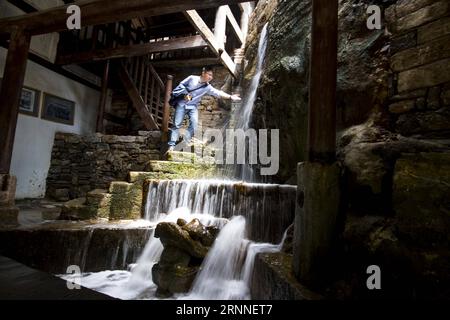 (170711) -- CHONGQING, 11 juillet 2017 -- une photo prise le 9 mai 2017 montre un touriste qui ressent l'eau d'une ancienne fosse à saumure dans l'ancienne ville de Wuxi à Ningchang, dans la municipalité de Chongqing au sud-ouest de la Chine. L'histoire de la production locale de sel ici peut être retracée à plus de 4 000 ans selon les archives historiques. Les puits de saumure à Wuxi ont servi de source clé de production de sel dans la région des trois Gorges. L ancienne route de commerce du sel, qui partait de l est du Sichuan, maintenant à l est de Chongqing, et traversait l arrière-pays de la Chine, servait de vecteur important d échanges économiques et culturels dans la commune Banque D'Images