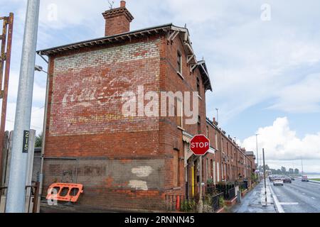 Signe fantôme Coca-Cola sur le pignon d'une terrasse sur Shore Road, Whiteabbey, Irlande du Nord. Banque D'Images