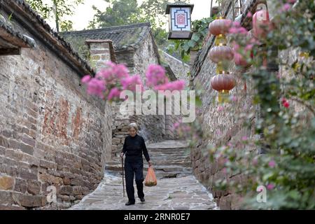 (170913) -- XINGTAI, 13 septembre 2017 -- Jiao Xiulan, âgé de 76 ans, descend une ruelle dans le village de Wangnao, dans la ville de Xingtai, province du Hebei, dans le nord de la Chine, 12 septembre 2017. La renommée de l'ancien village de Wangnao repose sur son style d'architecture traditionnelle chinoise où les routes pavées de dalles de pierre, les maisons avec des murs de briques rouges et des tuiles bleu-vert. Plus de 130 bâtiments anciens sont bien conservés ici.) (wyl) CHINE-HEBEI-XINGTAI-ANCIEN VILLAGE (CN) ChenxLei PUBLICATIONxNOTxINxCHN Banque D'Images