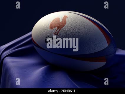 2 septembre 2023 - Bristol, Royaume-Uni : rendu 3D d'un ballon de rugby imprimé du logo France rugby reposant sur un tissu bleu drapé Banque D'Images