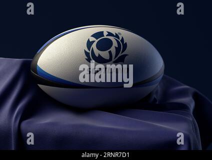 2 septembre 2023 - Bristol, Royaume-Uni : rendu 3D d'un ballon de rugby imprimé avec le logo de rugby Scotland reposant sur un tissu bleu drapé Banque D'Images