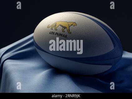 2 septembre 2023 - Bristol, Royaume-Uni : rendu 3D d'un ballon de rugby imprimé avec le logo Argentina rugby reposant sur un tissu bleu drapé Banque D'Images