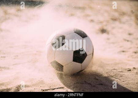 Particules de sable de ballon de football Banque D'Images