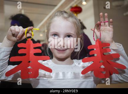 (180219) -- TORONTO, le 19 février 2018 -- Une fille pose pour des photos avec de l'artisanat découpé pendant la réception du nouvel an chinois de Toronto 2018 et le week-end de la fête de la famille au Musée royal de l'Ontario (ROM) à Toronto, Canada, le 18 février 2018. Mettant en vedette la découpe de papier chinois, la calligraphie, la danse du lion et plus encore, cet événement annuel du nouvel an chinois a débuté dimanche pour attirer des centaines de visiteurs pour célébrer le nouvel an lunaire chinois du chien au Musée royal de l'Ontario à Toronto. ) (srb) CANADA-TORONTO-CHINE NOUVEL AN-CÉLÉBRATION AU MUSÉE ZouxZheng PUBLICATIONxNOTxINxCHN Banque D'Images