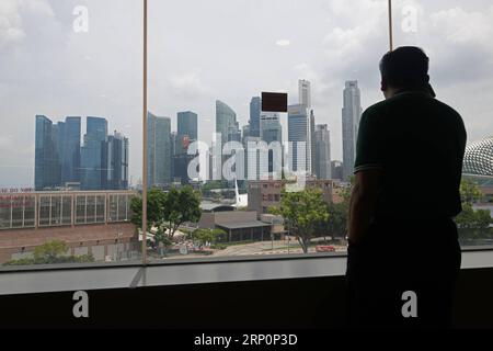 (180521) -- SINGAPOUR, le 21 mai 2018 -- Un homme utilise son téléphone portable à Marina Bay, le 21 mai 2018.) (zf) SINGAPORE-DAILY LIFE ThenxChihxWey PUBLICATIONxNOTxINxCHN Banque D'Images