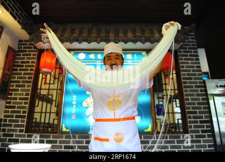 (180612) -- PÉKIN, 12 juin 2018 -- Quan Fujian tire des nouilles dans son restaurant de la ville de Yantai, dans la province du Shandong de l est de la Chine, le 7 juin 2018. La nouille Fushan est un plat traditionnel populaire dans la province du Shandong. Les nouilles sont tirées à la main et cuites avec diverses sauces et bouillons. La fabrication des nouilles Fushan a été inscrite au patrimoine culturel immatériel provincial du Shandong en 2013. (wsw) CHINE-SHANDONG-FABRICATION DE NOUILLES (CN) RenxPengfei PUBLICATIONxNOTxINxCHN Banque D'Images