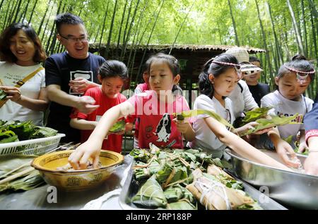 (180616) -- LINYI, 16 juin 2018 -- des touristes fabriquent zongzi , une boulette en forme de pyramide faite de riz gluant enveloppé dans des feuilles de bambou ou de roseau, lors d'un concours dans le village de Zhuquan du comté de Yinan, province du Shandong dans l'est de la Chine, le 16 juin 2018. )(MCG) CHINE-DRAGON BOAT FESTIVAL-FOLK CUSTOM (CN) WangxYanbing PUBLICATIONxNOTxINxCHN Banque D'Images