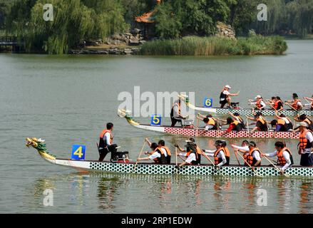 (180630) -- PÉKIN, le 30 juin 2018 -- des équipes de bateaux-dragons s'affrontent dans le lac Fuhai du parc Yuanmingyuan, ou l'ancien palais d'été, à Pékin, capitale de la Chine, le 30 juin 2018. Les gens se sont réunis ici samedi pour célébrer le 30e anniversaire de l’ouverture officielle du parc Yuanmingyuan au public. L'ancien palais d'été à la périphérie nord-ouest de Pékin a été restauré à partir des ruines de l'ancien jardin impérial Yuanmingyuan construit en 1709. Il a été incendié par les troupes britanniques et françaises en 1860, partiellement reconstruit, puis saccagé à nouveau par les forces alliées de huit puissances étrangères envahissantes i. Banque D'Images