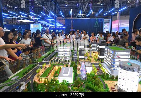 (180823) -- CHONGQING, 23 août 2018 -- les gens regardent une table de sable de transport urbain à la première Smart China Expo dans la municipalité de Chongqing du sud-ouest de la Chine, le 23 août 2018. Avec Smart Technology : Empowering Economy, Enriching Life comme thème, la première Smart China Expo se déroulera du jeudi au samedi et se concentrera sur les nouveaux produits, technologies et modes dans le développement mondial du big data et des industries intelligentes. L'expo dispose de cinq zones d'exposition d'une superficie totale de 186 000 mètres carrés, attirant plus de 500 entreprises nationales et internationales en tant qu'exposants et plus de 100 Banque D'Images