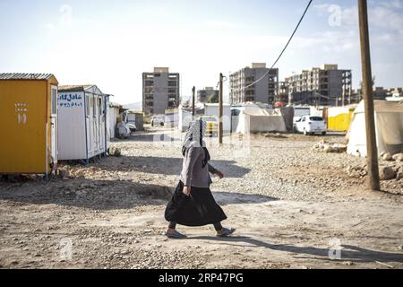 (181030) -- SARPOL-E ZAHAB (IRAN) , 30 octobre 2018 -- Une femme passe devant des bâtiments inachevés après près d'un an du douloureux tremblement de terre à Sarpol-e Zahab, Iran, le 29 octobre 2018. Le tremblement de terre de magnitude 7,3 a frappé la province de Kermanshah le 12 novembre 2017, faisant des centaines de morts. ) (YY) IRAN-SARPOL-E ZAHAB-VIE APRÈS LE TREMBLEMENT DE TERRE AhmadxHalabisaz PUBLICATIONxNOTxINxCHN Banque D'Images