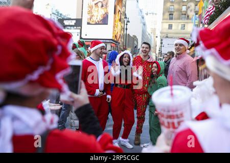 (181208) -- NEW YORK, 8 décembre 2018 -- les fêtards posent pour des photos lors de la SantaCon 2018 à New York, aux États-Unis, le 8 décembre 2018. Habillés en Père Noël ou en costumes festifs, des centaines de personnes ont participé à la SantaCon 2018 samedi, profitant de l'atmosphère de Noël et amassant des fonds pour la charité. US-NEW YORK-2018 SANTACON WangxYing PUBLICATIONxNOTxINxCHN Banque D'Images