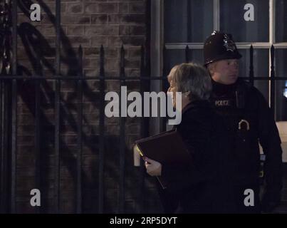 (181210) -- LONDRES, le 10 décembre 2018 -- la première ministre britannique Theresa May (Front) arrive au 10 Downing Street après avoir fait une déclaration à la Chambre des communes, à Londres, en Grande-Bretagne, le 10 décembre 2018. Theresa May a freiné lundi le vote serré sur son accord sur le Brexit au Parlement afin de gagner plus de temps pour de nouvelles discussions avec les dirigeants de l’Union européenne, qui ont affirmé que l’accord, conclu le mois dernier, n’est pas négociable. GRANDE-BRETAGNE-LONDRES-PM-BREXIT VOTE-REPOUSSANT HANXYAN PUBLICATIONXNOTXINXCHN Banque D'Images