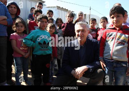 (190310) -- BEYROUTH, le 10 mars 2019 -- Filippo grandi (2e R, front), Haut Commissaire des Nations Unies pour les réfugiés, pose pour des photos avec des enfants dans un camp de réfugiés syriens à Akkar, au nord du Liban, le 9 mars 2019. Filippo grandi a déclaré vendredi que son agence travaillait avec les autorités syriennes pour lever les obstacles au retour des réfugiés syriens dans leur patrie, ont rapporté les médias locaux. Plus de 1 millions de réfugiés syriens se sont enregistrés auprès du HCR au Liban, tandis que le gouvernement estime le nombre réel de Syriens au Liban à 1,5 millions. LIBAN-RÉFUGIÉS SYRIENS-OFFICE DES NATIONS UNIES POUR LES RÉFUGIÉS C Banque D'Images