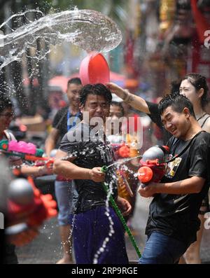 (190415) -- XISHUANGBANNA, 15 avril 2019 -- des gens célèbrent la fête de l'aspersion d'eau dans une rue de la ville de Jinghong, préfecture autonome de Dai de Xishuangbanna, dans le sud-ouest de la province du Yunnan, le 15 avril 2019. Les gens s'aspergent d'eau les uns les autres pour prier pour la bonne fortune pendant le festival traditionnel d'aspersion d'eau, qui est aussi le festival du nouvel an du groupe ethnique Dai. Qin Qing) CHINA-YUNNAN-XISHUANGBANNA-WATER SPRINKLING FESTIVAL (CN) qinqing PUBLICATIONxNOTxINxCHN Banque D'Images