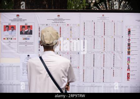 (190417) -- JAKARTA, 17 avril 2019 (Xinhua) -- Un électeur vérifie les informations sur les candidats dans un bureau de vote à Jakarta, Indonésie, le 17 avril 2019. Les électeurs indonésiens ont commencé à voter mercredi alors que des bureaux de vote ont ouvert dans l'est du vaste pays archipélagique pour élire un président et des membres du Parlement. (Xinhua/du Yu) INDONÉSIE-JAKARTA-ELECTION-VOTE PUBLICATIONxNOTxINxCHN Banque D'Images