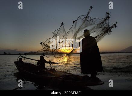 (190507) -- PÉKIN, le 7 mai 2019 -- Un pêcheur jette son filet au coucher du soleil au lac Dal dans la ville de Srinagar, capitale estivale du Cachemire contrôlé par l'Inde, le 5 mai 2019.) PHOTOS XINHUA DU JOUR JavedxDar PUBLICATIONxNOTxINxCHN Banque D'Images