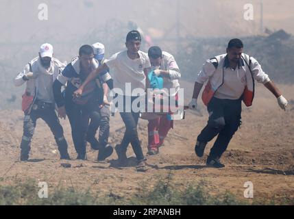(190515) -- GAZA, 15 mai 2019 -- des médecins palestiniens transportent un blessé lors d'affrontements avec les troupes israéliennes à la frontière Gaza-Israël, à l'est du camp de réfugiés d'al-Bureij, dans le centre de Gaza, le 15 mai 2019. Au moins 47 Palestiniens ont été blessés mercredi dans leurs affrontements avec des soldats israéliens, alors qu’ils célébraient le 71e anniversaire de la Nakba, ou jour de la catastrophe, le lendemain de la déclaration d’indépendance d’Israël en 1948. MIDEAST-GAZA-AFFRONTEMENTS YasserxQudih PUBLICATIONxNOTxINxCHN Banque D'Images